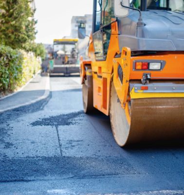 Tandem vibration roller compactor working on asphalt pavement