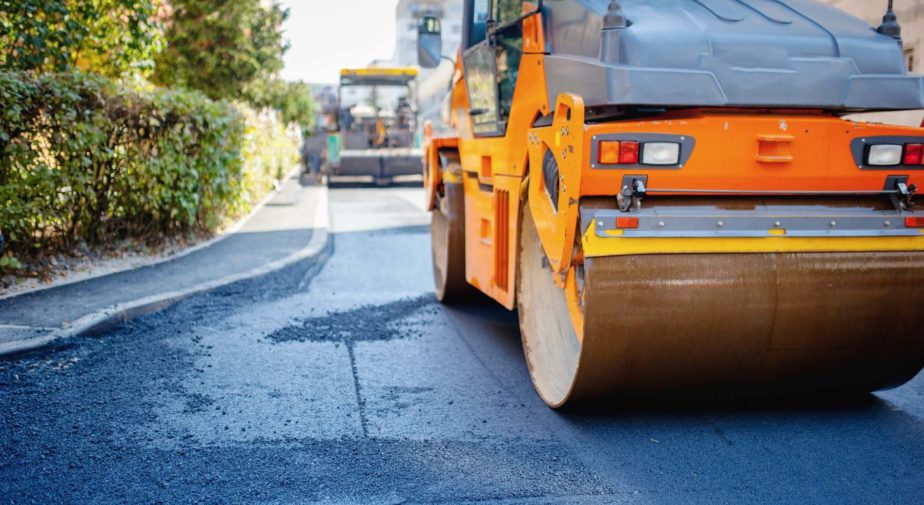 Tandem vibration roller compactor working on asphalt pavement