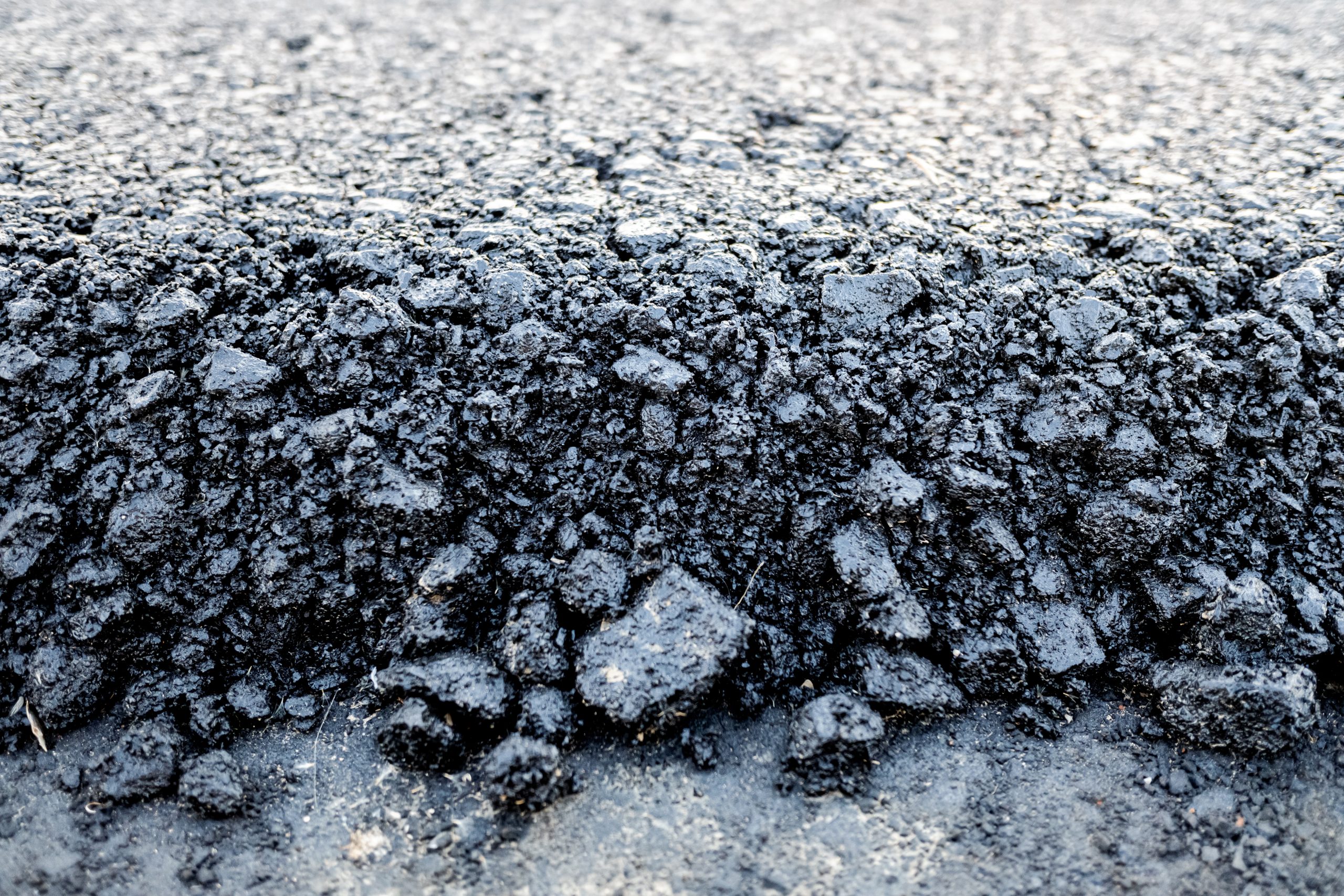 A close view of loose hot asphalt before it is compacted