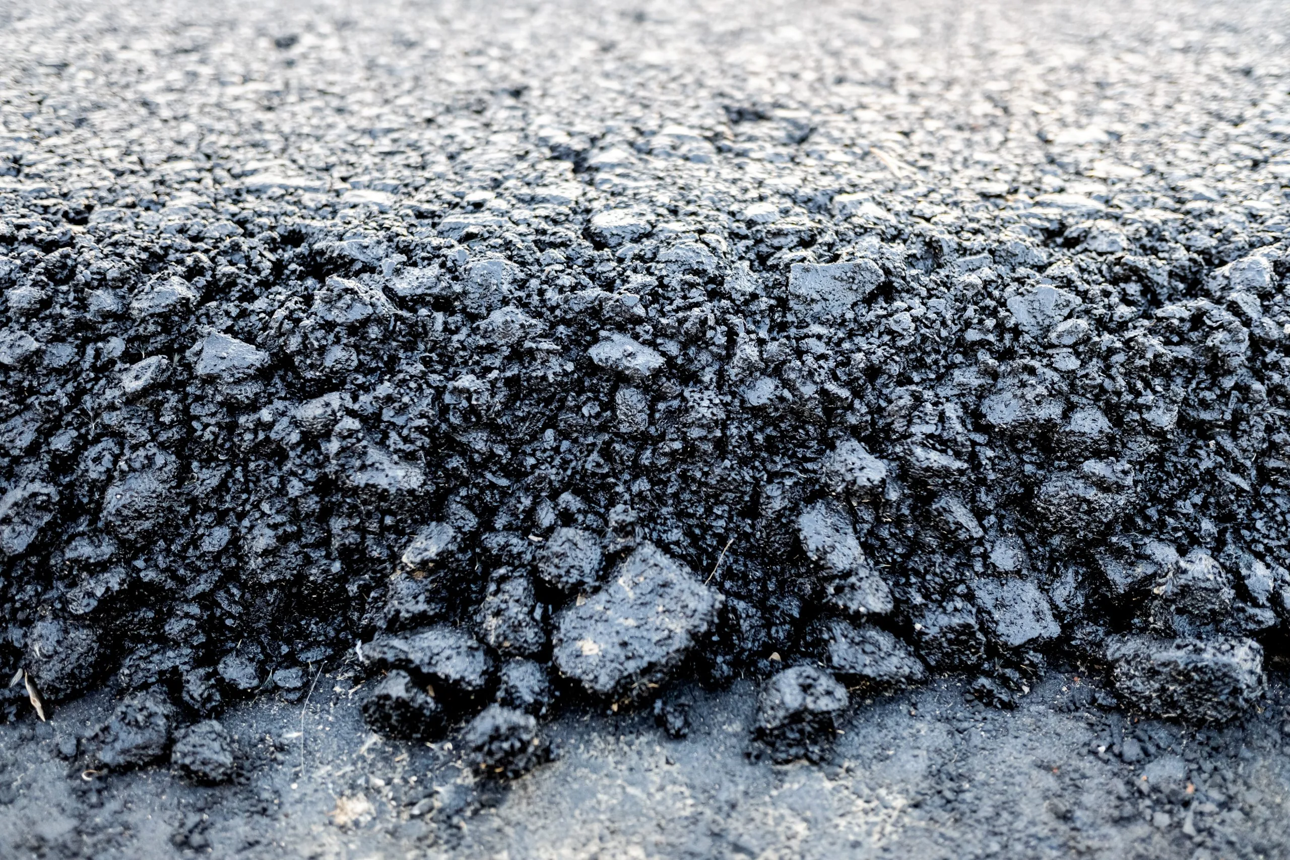 A close view of loose hot asphalt before it is compacted