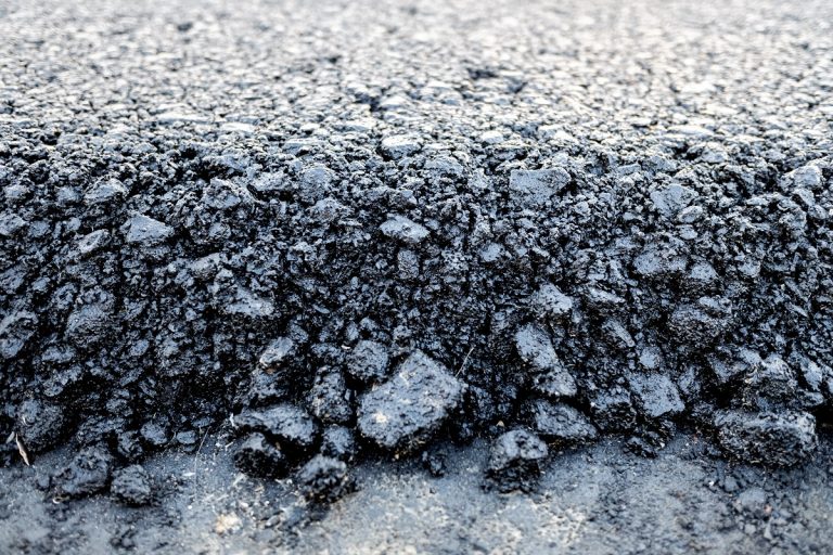 Loose asphalt mix at the edge of a mat before it is rolled