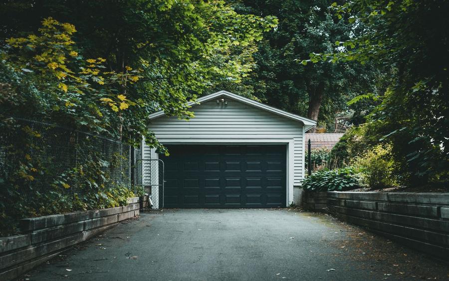 A paved residential driveway running up to a garage